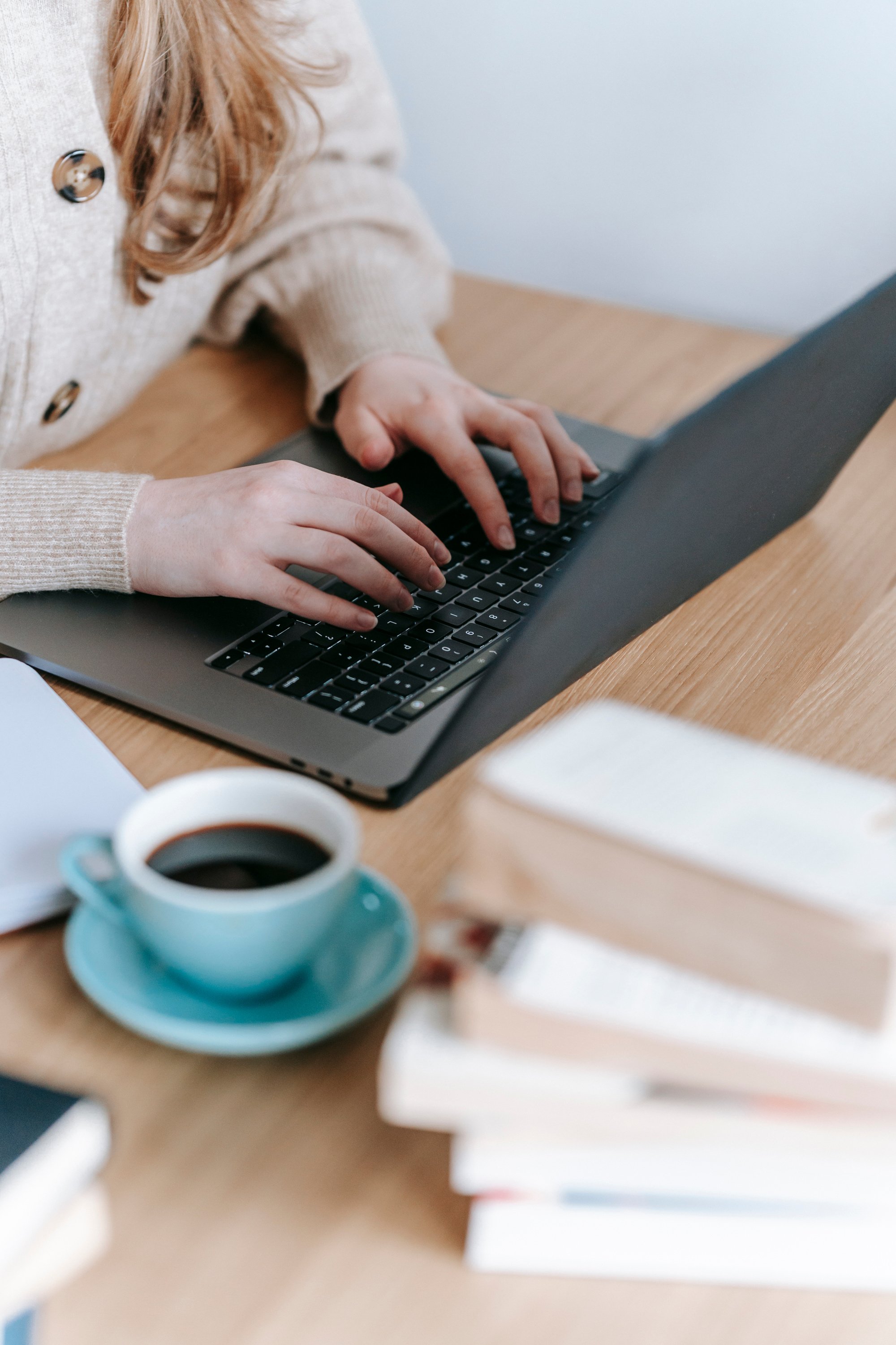 Unrecognizable woman typing on laptop